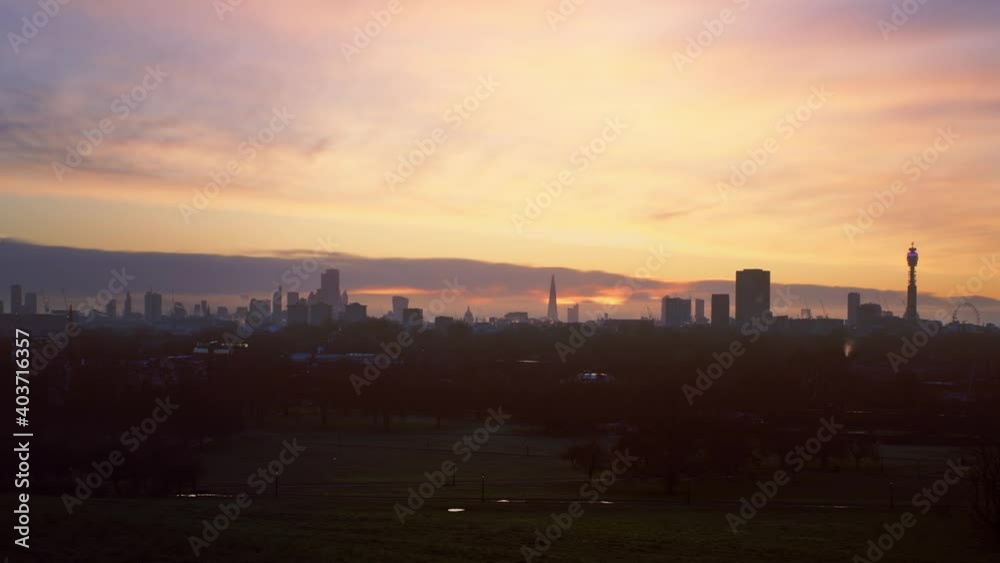 London skyline at sunrise from Primrose Hill in Regents Park. Famous landmarks include with slow pan up London skyline at sunrise from Primrose Hill in Regents Park. Famous landmarks include with slow pan up