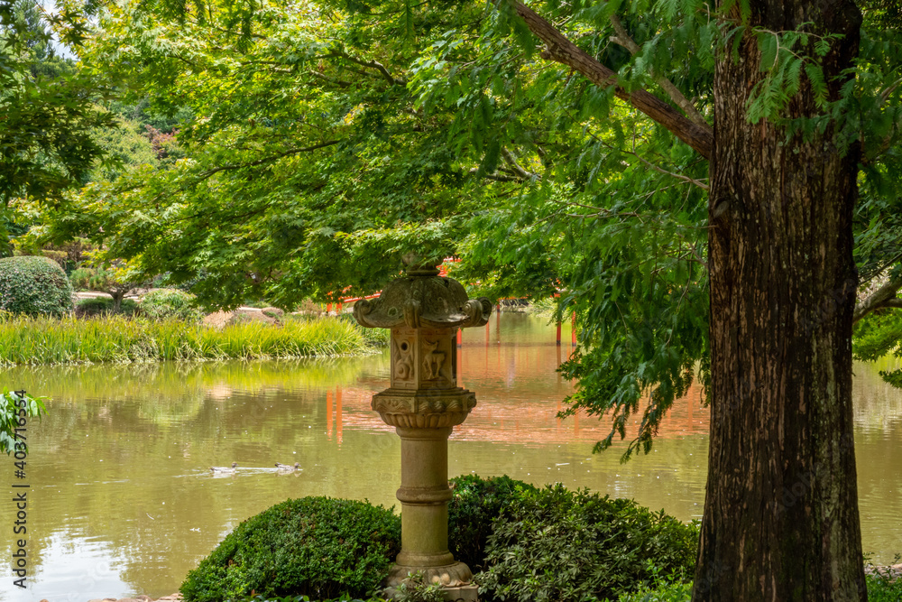 Japanese statue with the lake in the background Japanese statue with the lake in the background