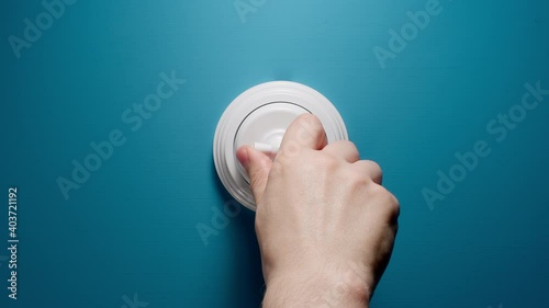 Human Switches On A Toggle Switch On The Blue Wall