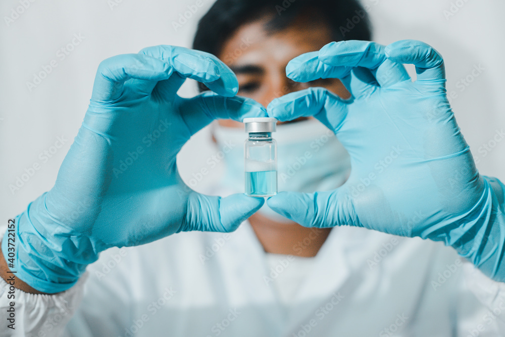 A doctor or scientist holding a vaccine with blue water Concept of virus protection.
