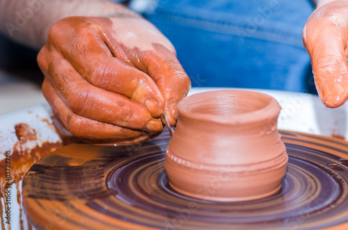 A man using a potter's wheel in pottery