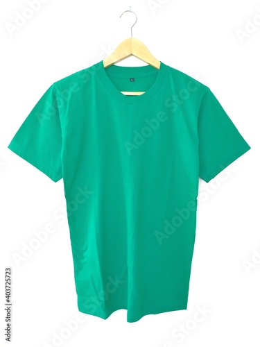 green t shirt on hanger with white background