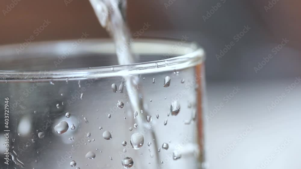 Filling a glass with water. Water Poured Into Glass Closeup. copyspace. Filling a glass with water. Water Poured Into Glass Closeup. copyspace.
