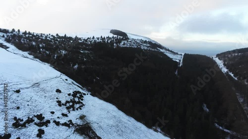 Snowy Welsh woodland Moel Famau winter landscape aerial view rural scene pan right photo