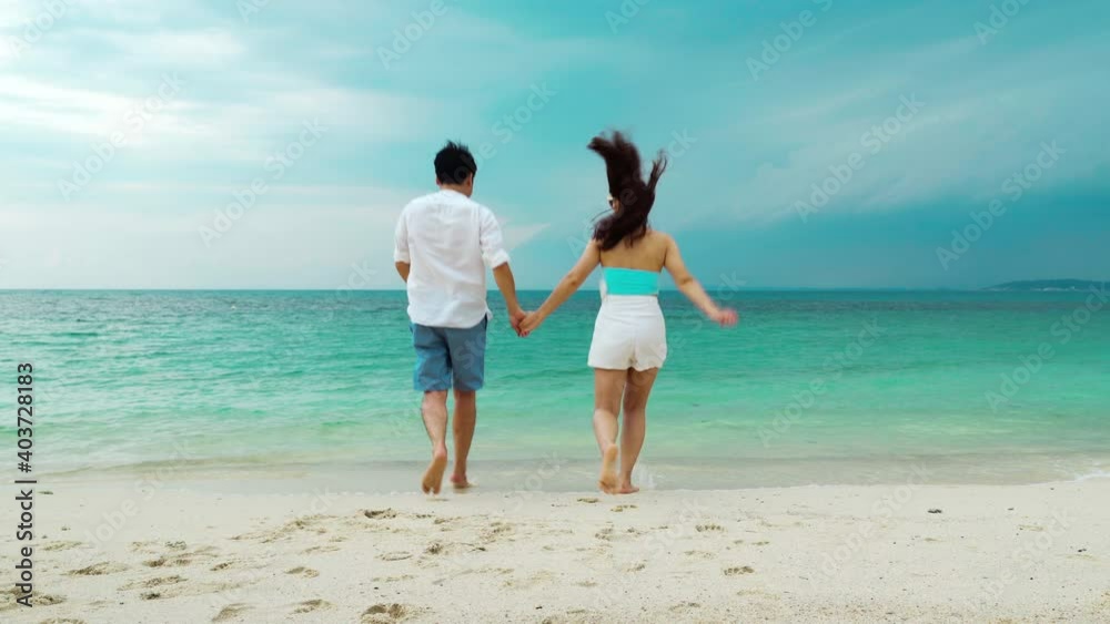 happy young couple running and having fun on the sea beach at Koh MunNork Island, Rayong, Thailand happy young couple running and having fun on the sea beach at Koh MunNork Island, Rayong, Thailand