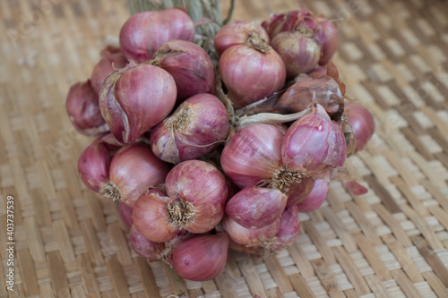 Red onion on bamboo basket.