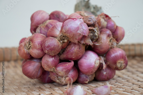 Red onion on bamboo basket.