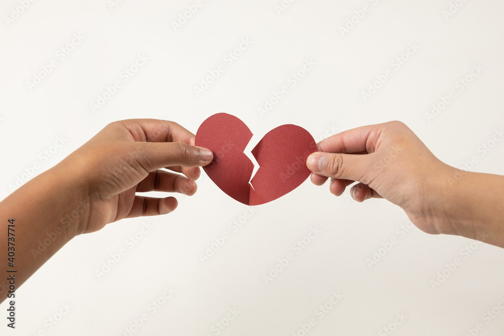 hands holding a broken heart, heartbreak concept