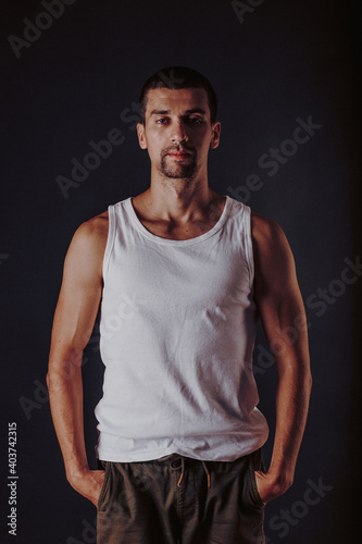 Wallpaper Mural handsome tanned athletic man in a white t-shirt on a wall photo Torontodigital.ca