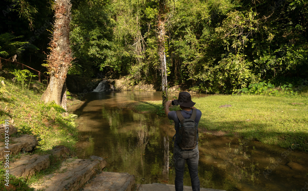 Natural waterfall scenery and hiking men