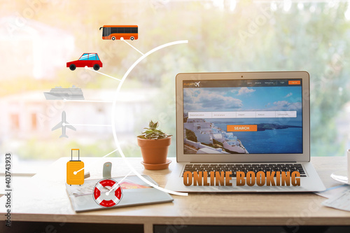 Open page of online booking service on screen of laptop on table