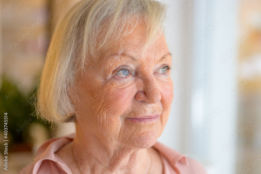 Lonely elderly woman standing reminiscing Lonely elderly woman standing reminiscing