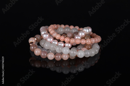 Obraz na płótnie Fashion accessories. Jewelry on black reflective background. Gemstone bracelets. Natural stones beads. w salonie