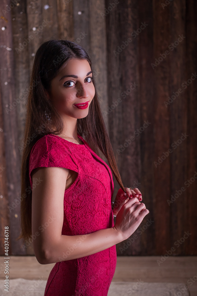 Fototapeta premium woman model in elegant red dress. Beautiful girl studio shot on wooden background.