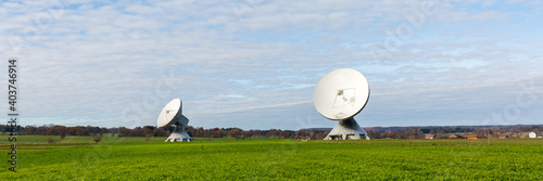 Two satellite dishes pointing towards the sky. In beautiful bavarian landscape. Part of the Raisting Radome.
