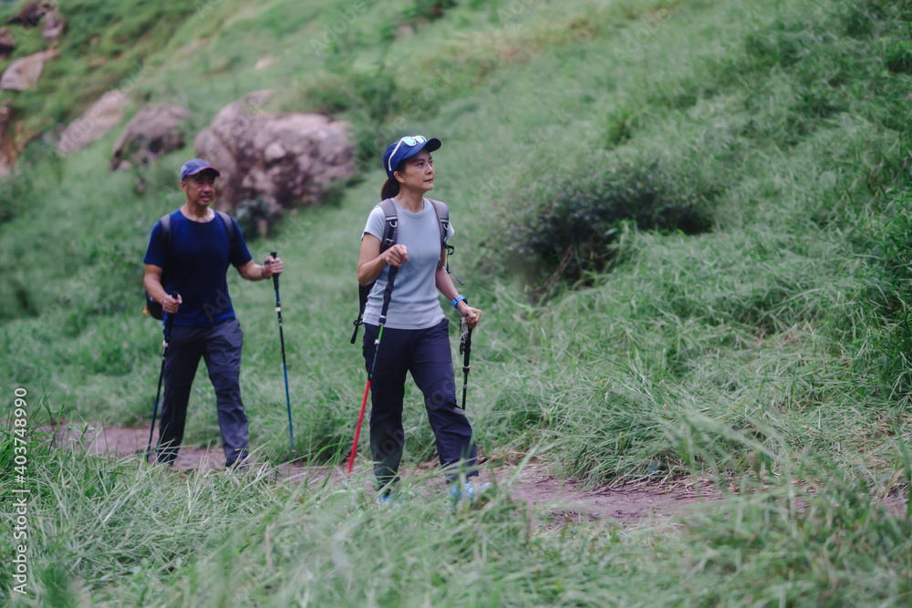 Asian middle-aged couple Are hiking on vacation