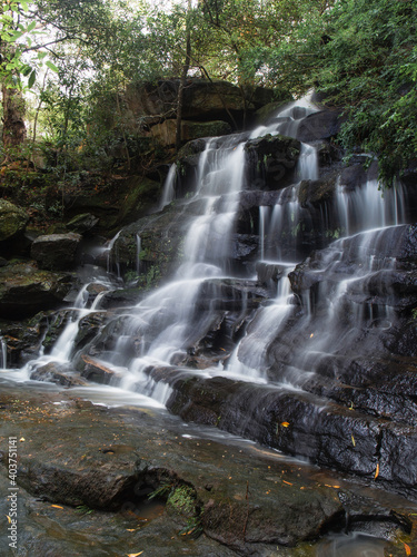 Side view of a tall rocky waterfall.