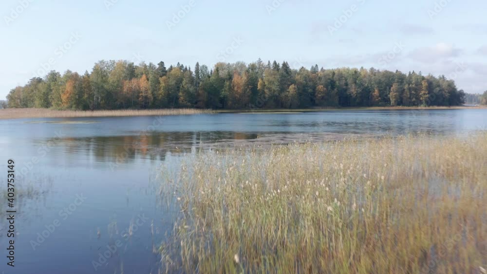 Drone flight over a picturesque autumn lake in Karelia, Russia, an island in Lake Vuoksa Drone flight over a picturesque autumn lake in Karelia, Russia, an island in Lake Vuoksa