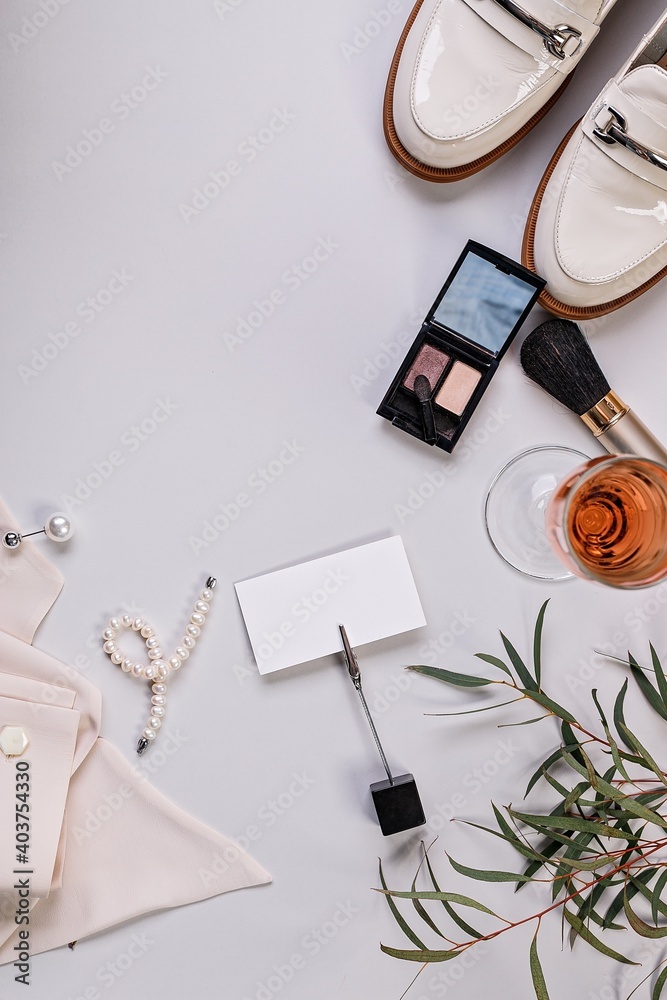 Cosmetics and fashion blogger background. Flat lay. Blank business card. Makeup, accessories on a light background. Top view. Vertical shot Cosmetics and fashion blogger background. Flat lay. Blank business card. Makeup, accessories on a light background. Top view. Vertical shot