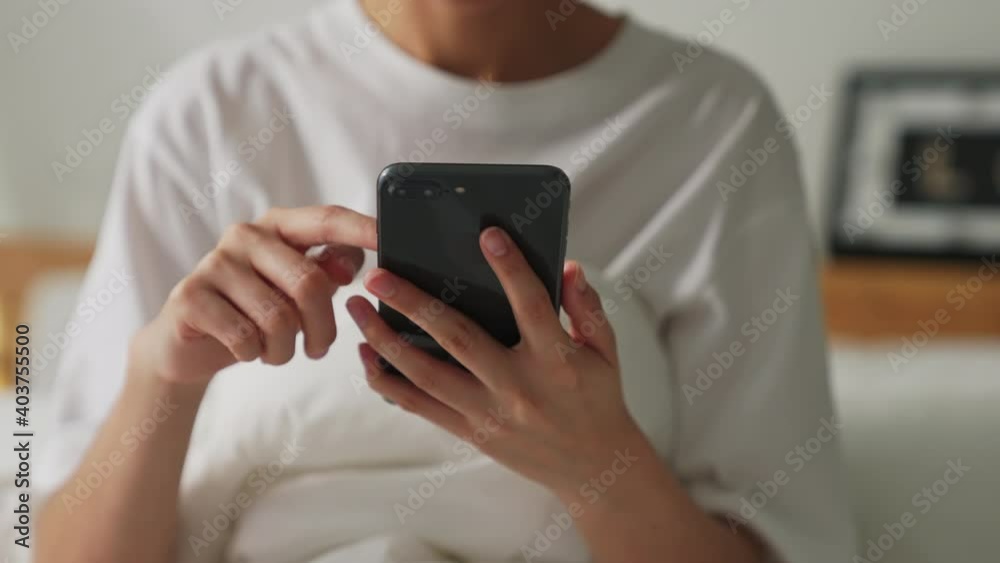Slow motion of woman using smartphone, During leisure time. The concept of using the phone is essential in everyday life. Slow motion of woman using smartphone, During leisure time. The concept of using the phone is essential in everyday life.