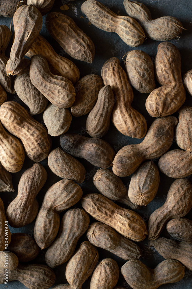 Roasted peanuts, cracked. On a grey background Roasted peanuts, cracked. On a grey background