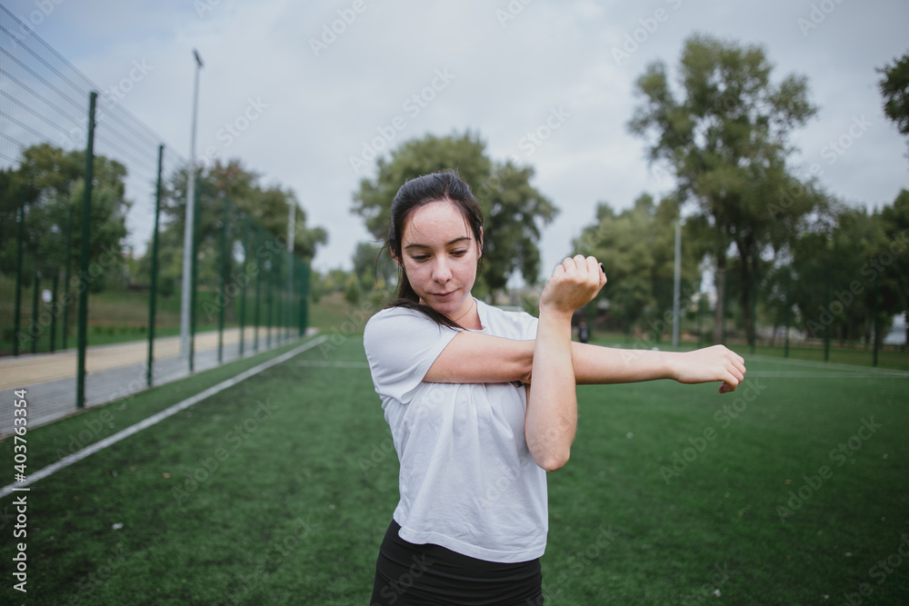Young woman do the workout plays sports in the park outside playground Young woman do the workout plays sports in the park outside playground
