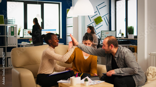 Happy leader motivate diverse employees business team give high five together, excited office workers group and coach engaged in teambuilding celebrate success good results reward in teamwork concept