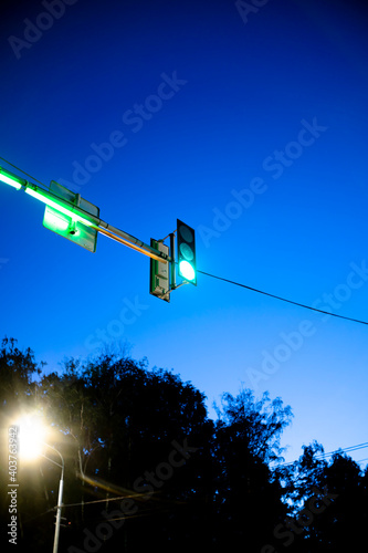 Green traffic light. Hinged traffic light at night.