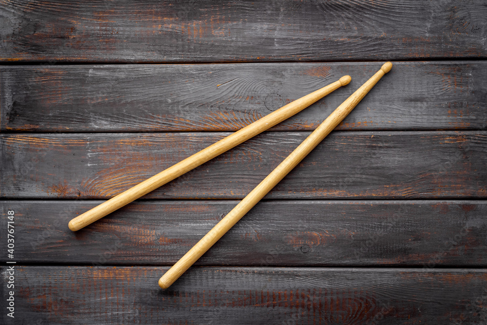 Two wooden drum sticks, top view. Music background Two wooden drum sticks, top view. Music background