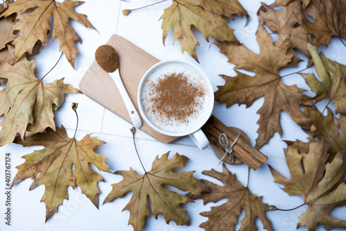 Hot, cinnamon and milk salep in a white glass. photo