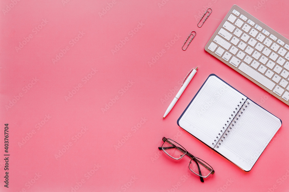 Pink flat lay top view office table desk with keyboard and office supplies Pink flat lay top view office table desk with keyboard and office supplies