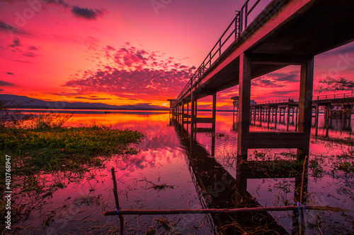 The background of the bridge stretches into the sea  with twilight light in the morning  beautiful colors  sky wallpaper and refreshing surroundings.