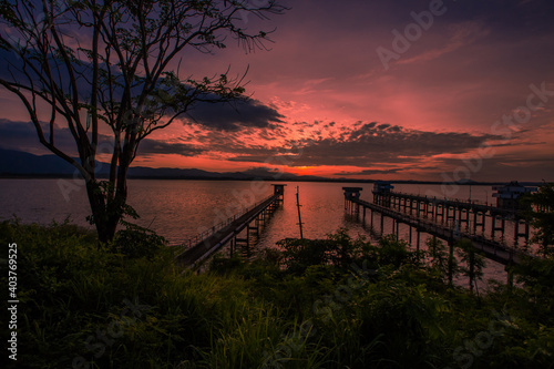 The background of the bridge stretches into the sea  with twilight light in the morning  beautiful colors  sky wallpaper and refreshing surroundings.