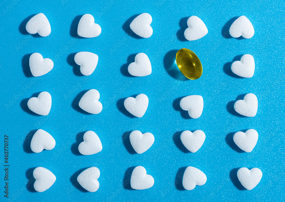 heart-shaped tablets and yellow gelatin pill. pattern medicine