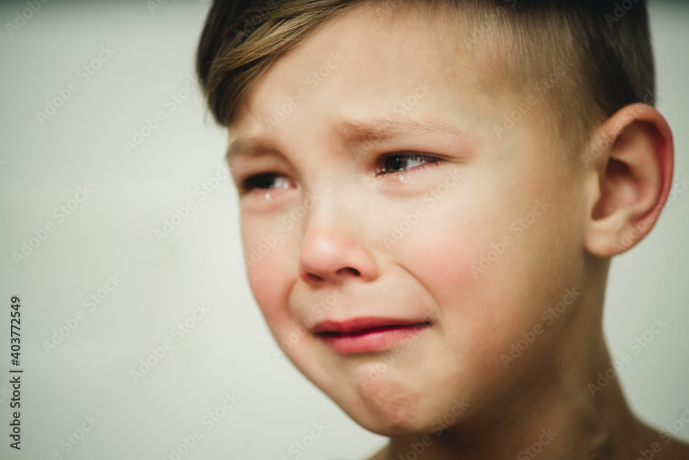 portrait of a crying boy on a white background close-up portrait of a crying boy on a white background close-up