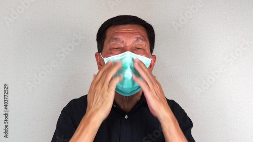 Senior man wearing medical face mask close up