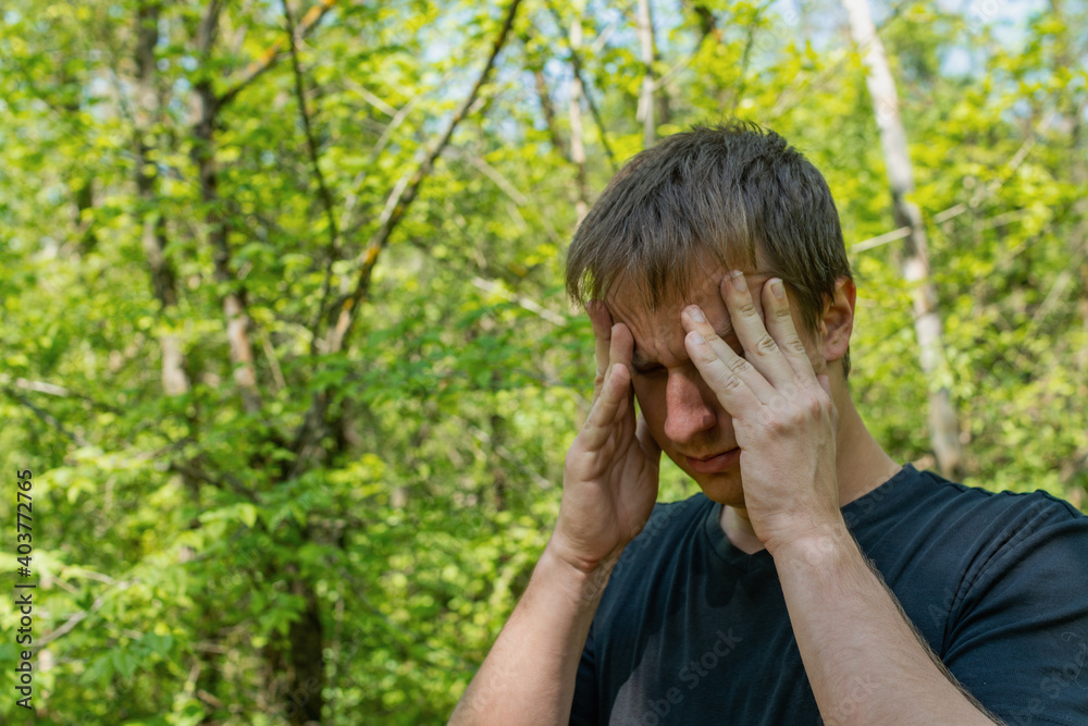 Man in depression with hands on forehead