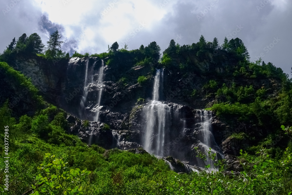 beautiful high waterfalls over rocks on a mountain beautiful high waterfalls over rocks on a mountain