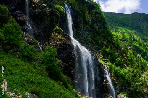 beautiful high waterfall over rocks detail view © thomaseder
