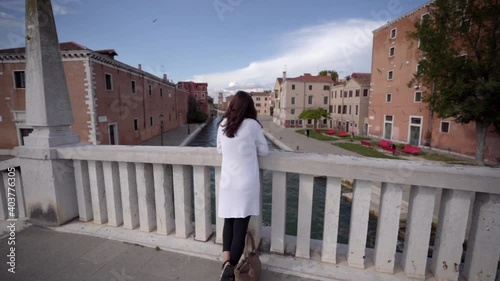 Wallpaper Mural Attractive young woman walk on the bridge in Venice Italy looking at the blue sky. Torontodigital.ca