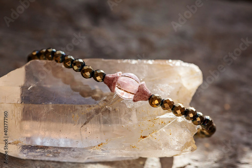 Mineral gemstone bracelet placed on natural grey background