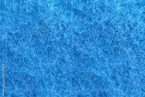 Blue felt texture. Full frame macro photography of wool fiber non-woven textile material. Abstract pattern background. Close-up design element.