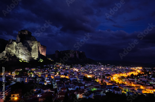 Night view of Kalambaka and Kastraki village at foot of high cliffs and rocks of Meteora valley. Greece, UNESCO World Heritage