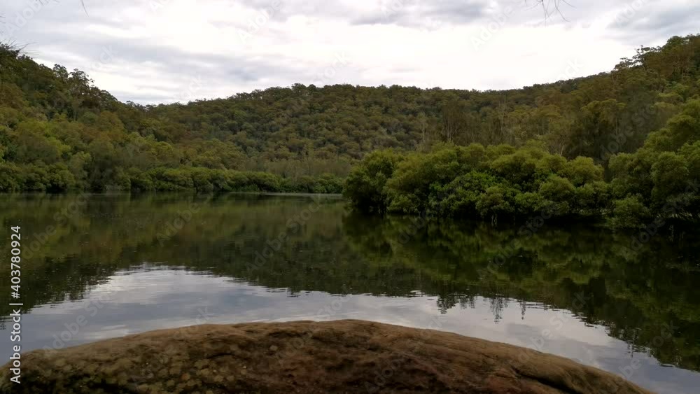 Time lapse video of a river with beautiful reflections of mountains, trees and clouds on water, Crosslands Reserve, Berowra Valley National park, Sydney, New South Wales, Australia
Time lapse video of a river with beautiful reflections of mountains, trees and clouds on water, Crosslands Reserve, Berowra Valley National park, Sydney, New South Wales, Australia
