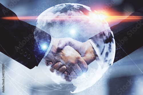 Double exposure of business theme hologram and handshake of two men. Success concept.