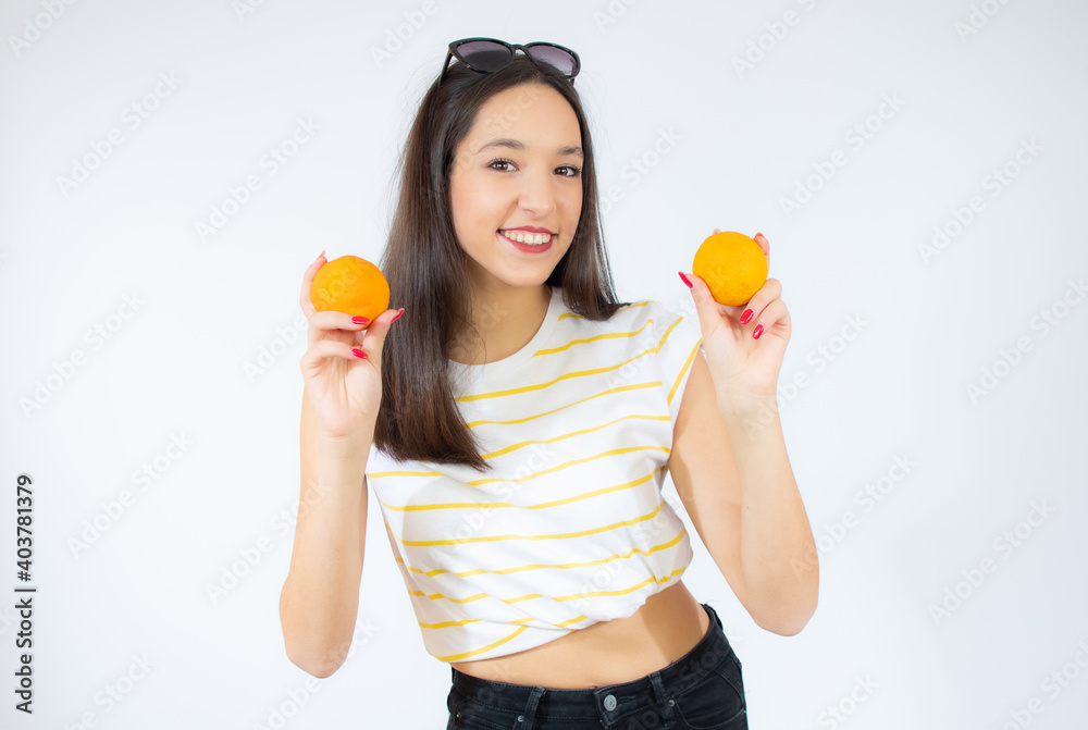 Teenager girl holding two oranges isolated on white background Teenager girl holding two oranges isolated on white background