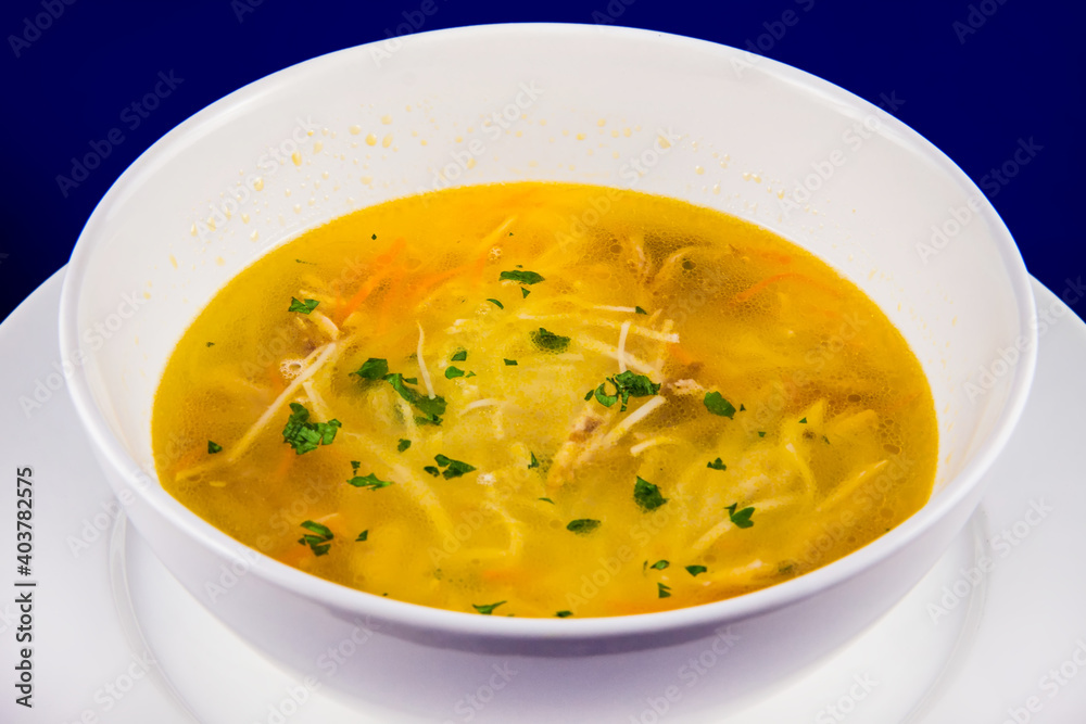 Hot chicken noodle soup with carrots and herbs Hot chicken noodle soup with carrots and herbs