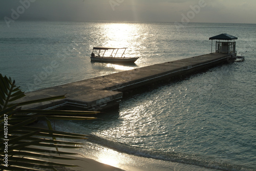 Jetty and a boat at sunset in the Caribbean