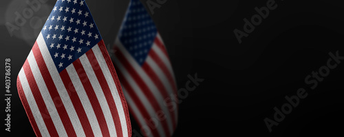 Small national flags of the United States on a dark background