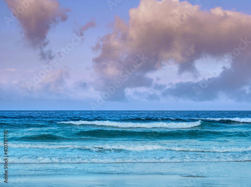 Waves lap at dawn on the beach in Tarifa, Spain